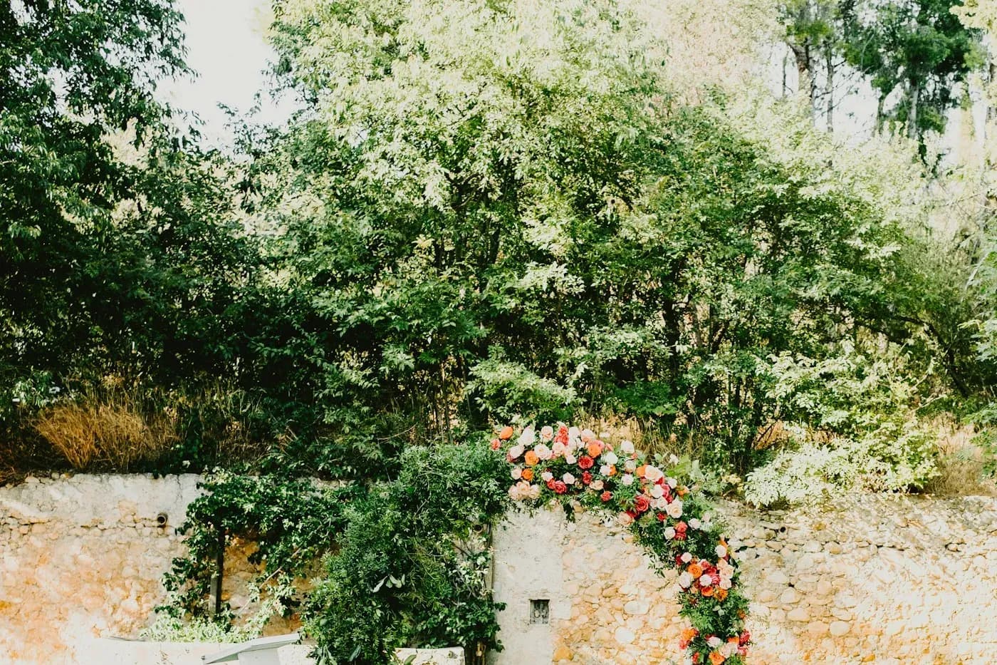 Sage green florals in a garden wedding setup