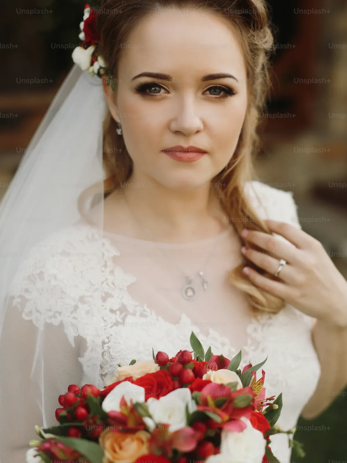 Bride in a veil holding a bouquet, ready for the ceremony