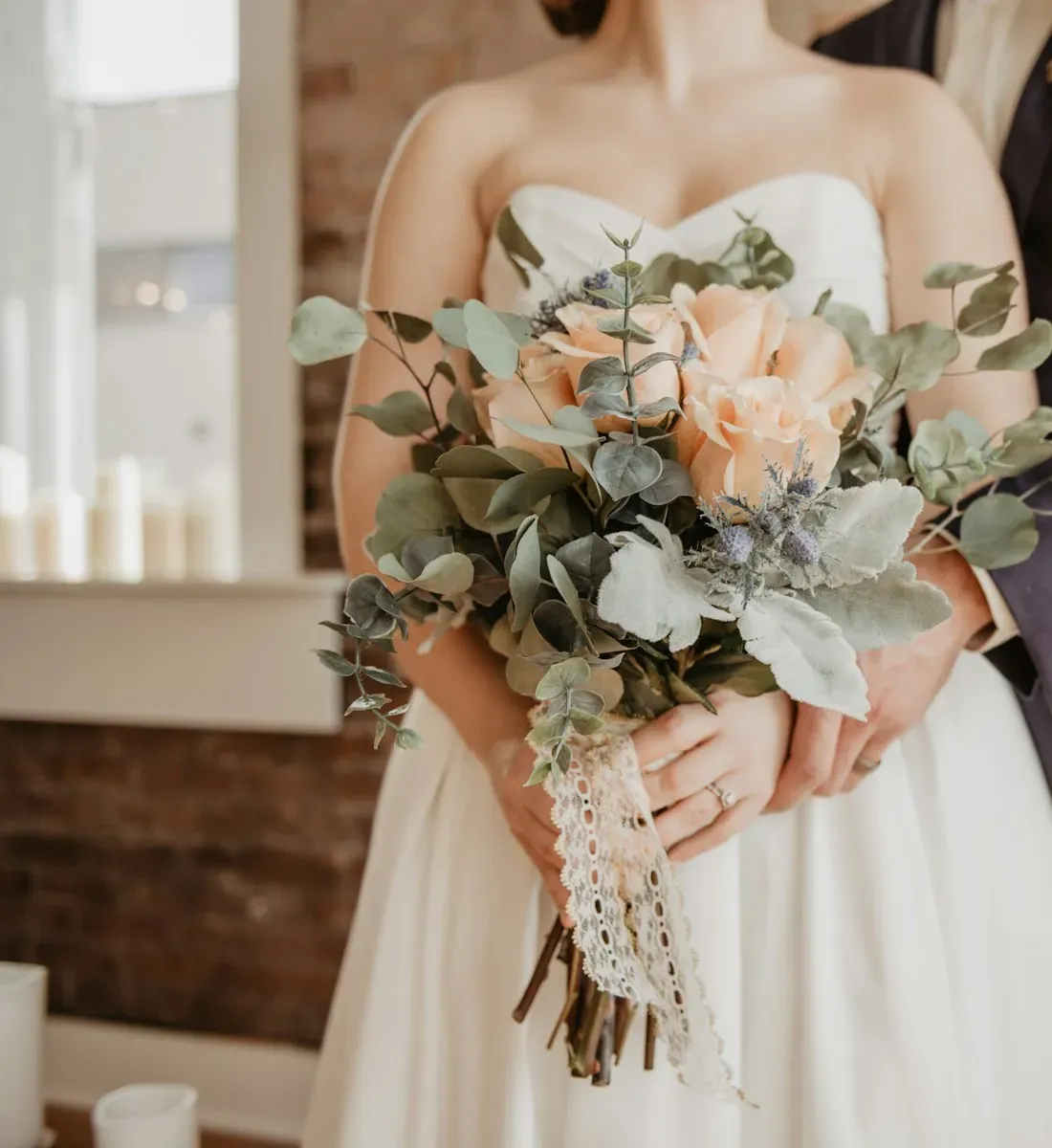 A bride holding a soft pastel wedding bouquet